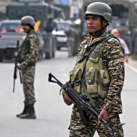 Indian security personnel stand guard in Wuyan