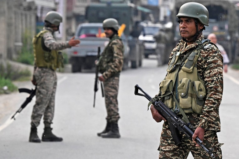Indian security personnel stand guard in Wuyan